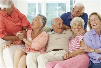 Senior friends talking in living room