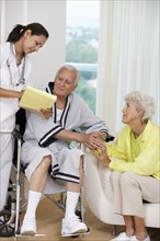 Nurse talking to Senior couple