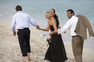 Couples walking together on beach