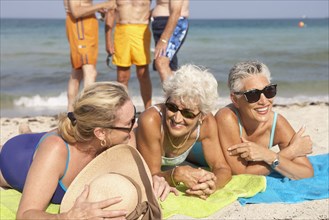 Senior women relaxing on beach