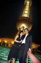 Couple below Oriental Pearl Tower at night
