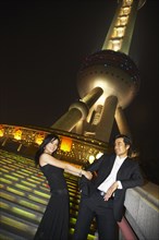 Couple below Oriental Pearl Tower at night