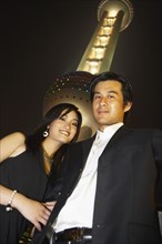 Couple under Oriental Pearl Tower at night