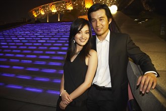 Couple outside Oriental Pearl Tower at night