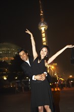 Couple outside Oriental Pearl Tower at night