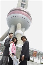 Chinese business people under Oriental Pearl Tower
