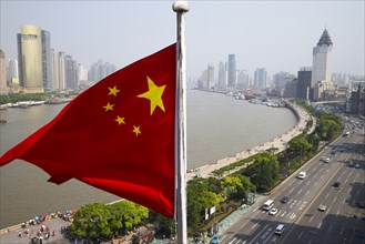 Chinese flag overlooking cityscape
