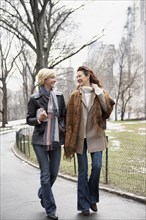 Women walking together in urban park