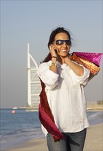 Middle Eastern woman smiling on beach