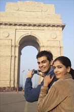 Indian couple photographing India Gate