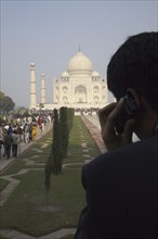 Indian businessman on cell phone by Taj Mahal
