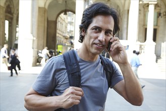 Man talking on cell phone on city street