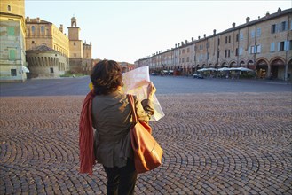 Women reading map in town square