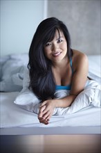 Smiling woman laying in bed