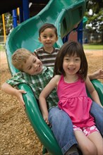 Children sliding in playground