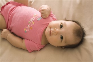 Chinese baby girl laying on bed