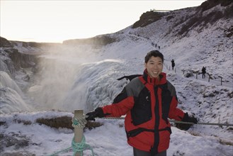 Chinese man standing on remote ice field