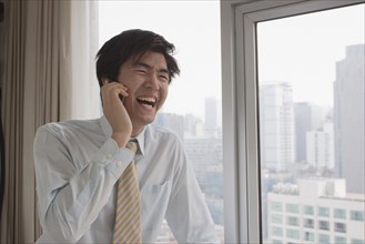 Chinese businessman talking on cell phone