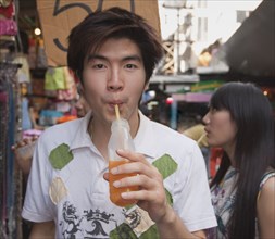 Chinese man drinking juice