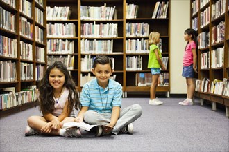Children sitting on library floor
