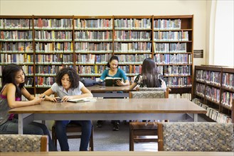 People reading books in library