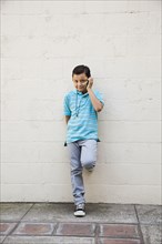 Mixed race boy talking on cell phone