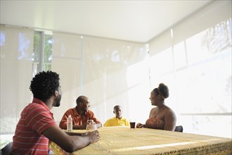 Black family sitting at dining room table