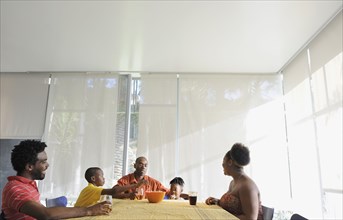 Black family eating at dining room table