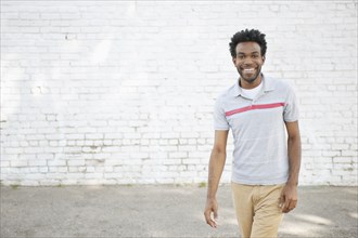 African American man standing on sidewalk