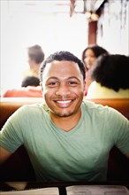 Smiling mixed race man in diner