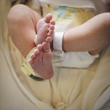 Close up of feet of mixed race newborn baby