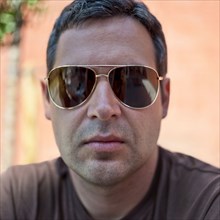 Serious Caucasian man wearing sunglasses