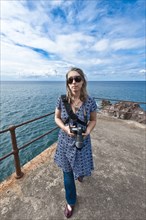 Caucasian woman on jetty with camera