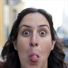 Caucasian woman sticking out tongue