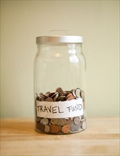 Coins in 'travel fund' jar