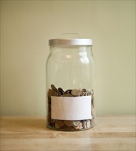 Coins in blank labeled jar