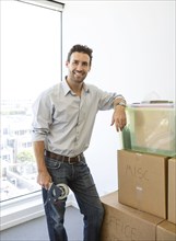 Hispanic man packing cardboard boxes