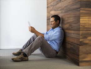 Hispanic businessman using digital tablet