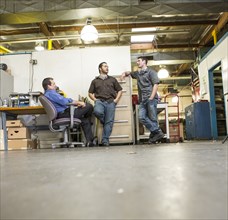 Manager and workers talking in warehouse