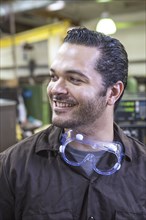 Hispanic worker smiling in warehouse