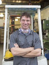 Caucasian worker smiling in warehouse