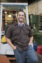 Hispanic worker smiling in warehouse