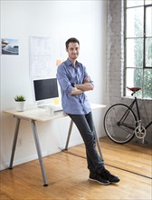 Caucasian architect smiling in office