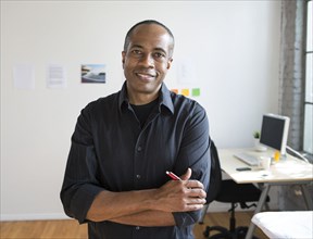 African American architect smiling in office