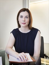 Caucasian businesswoman sitting at desk in office