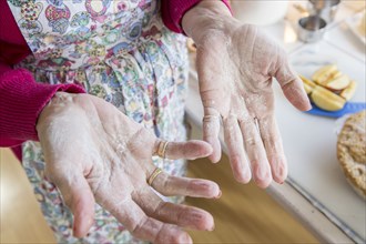 Close up of flour on hands of older Caucasian woman