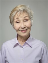 Close up of older Japanese woman smiling