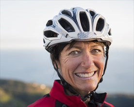 Close up of smiling Caucasian woman wearing helmet