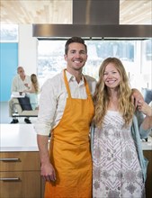 Caucasian couple smiling in kitchen