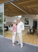 Older Caucasian couple smiling on porch